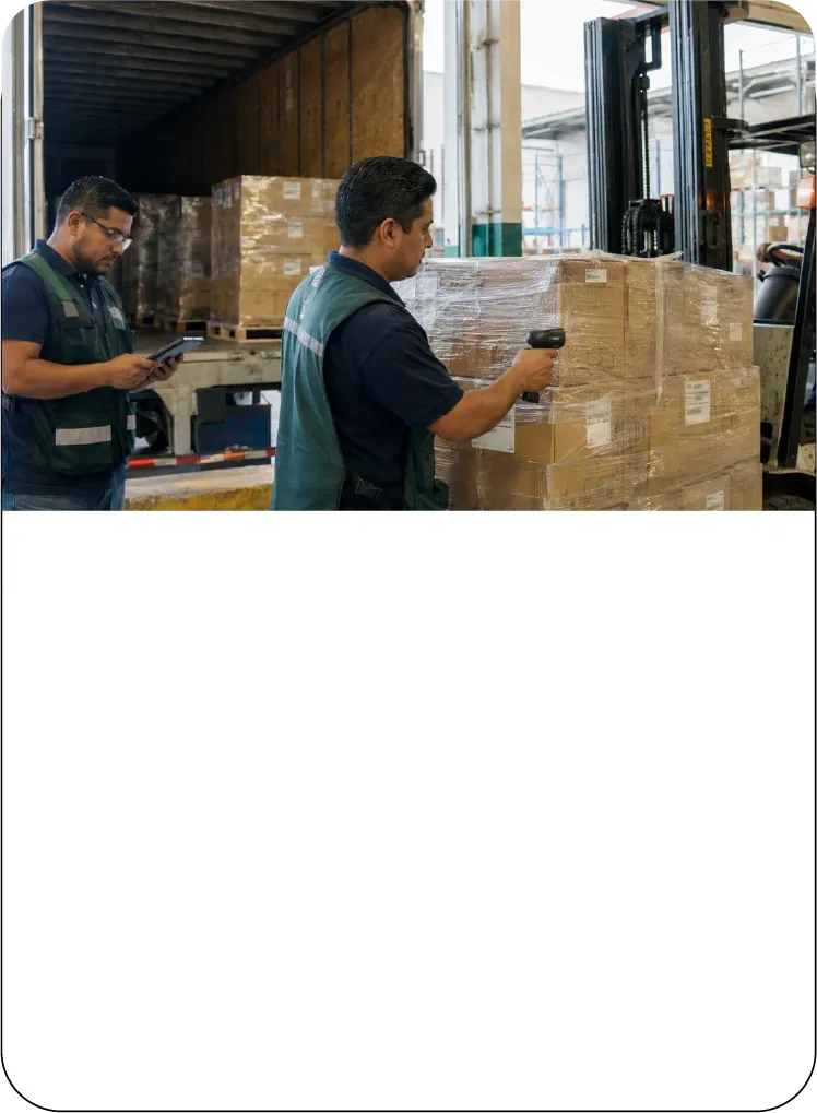 Personal operativo cargando mercancía en una caja de tráiler